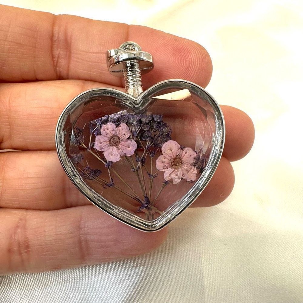 Glass heart pendant with dried flowers